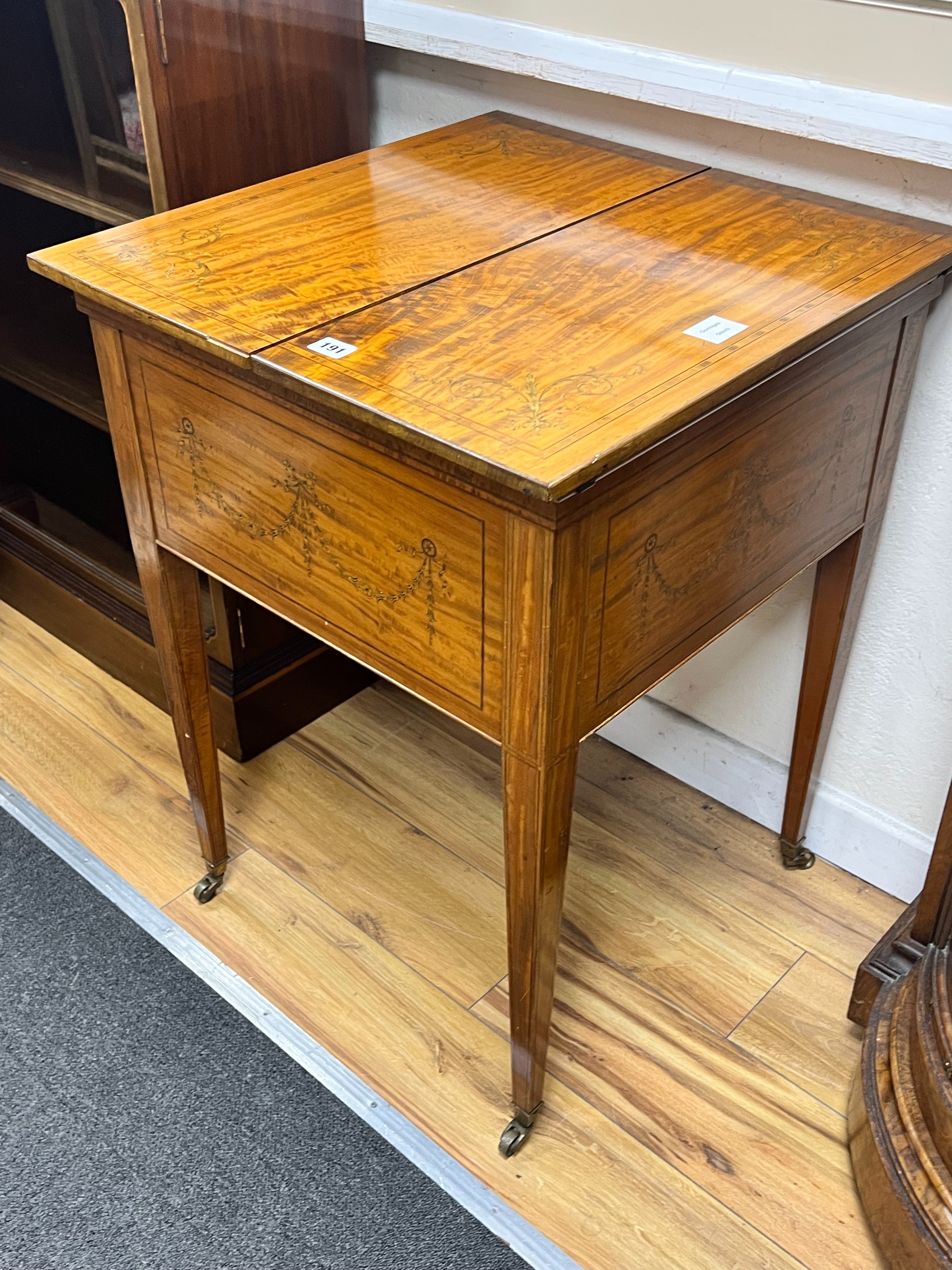An Edwardian banded satinwood mahogany surprise drinks cabinet by Maple & Co, banded in kingwood and inlaid with husk festoons, divided opening top with rising interior, circa 1900., width 56cm depth 59cm height 78cm